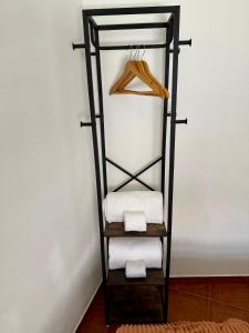 a black towel rack with towels and a hanger at Casa D Dinis in Alfaiates +39 photos