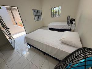 a hospital room with two beds and a window at Hostal Charlotte in La Unión