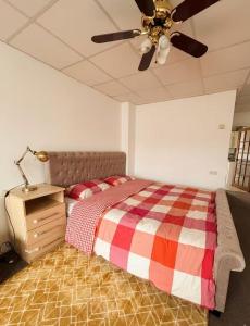 a bedroom with a bed and a ceiling fan at Stylish Studio with SuperKing Bed in Stonewood