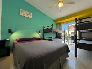 a bedroom with a bed and two bunk beds at Link Cordoba Hostel in Córdoba +116 photos