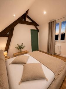 a large bedroom with two beds and a window at LE JEAN JAURÈS Arrivée Autonome in Vierzon