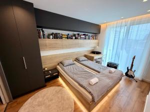 a bedroom with a bed and a guitar in it at Rupphill Apartment in Budapest