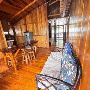 a living room with a couch and a table and chairs at Hostal Vista Verde in Mindo