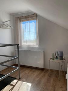 a white room with a window and a table at Bobo Hegyi Kuckó in Sárvár