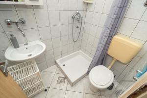 a bathroom with a toilet and a sink and a shower at Apartments Saric in Jadrtovac +63 photos