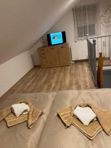 a bedroom with a bed with two towels on it at Bobo Hegyi Kuckó in Sárvár