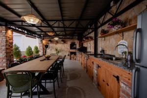 a kitchen with a long wooden table and chairs at Villa Aurora in Ohrid