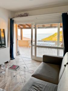a living room with a couch and a glass table at Casa il Bouganville - sea view Costa Paradiso in Costa Paradiso