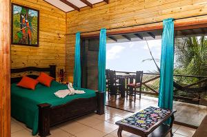 a bedroom with a bed and a balcony at Pirate Cove in Drake
