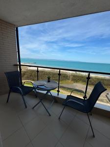 a balcony with a table and chairs and the ocean at Infinity Sea View Studio in Pomorie