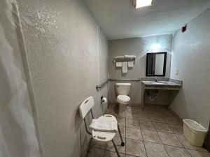 a bathroom with a toilet and a sink at Speedway Inn & Suites in Griffin