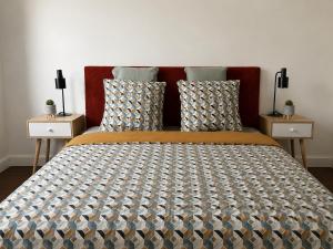 a bedroom with a large bed with two night stands at Cosy Normandy - Bloom in Sourdeval