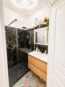 a bathroom with a sink and a shower at Cosy Normandy - Bloom in Sourdeval