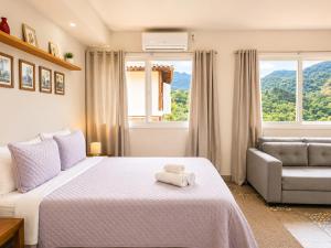 a bedroom with a bed with a teddy bear on it at Pousada Santa Fe de Penedo in Penedo +135 photos