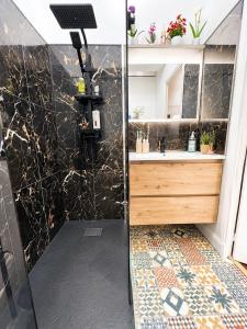 a bathroom with a shower and a sink at Cosy Normandy - Bloom in Sourdeval +9 photos