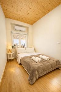 a bedroom with a large bed with a wooden ceiling at MARY'S HOUSE The lux terrace in Tripoli
