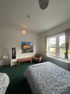 a bedroom with a bed and a tv on the wall at Eva lodges in Manchester