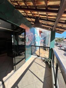 a building with a mural on the side of it at Chamos Hostel Cultural in Arraial do Cabo