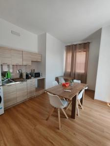 a kitchen with a wooden table and chairs in a room at Termoli in una stanza in Termoli