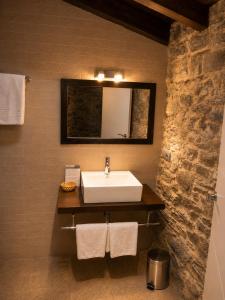 a bathroom with a sink and a mirror at Hostal Ultreia in Villafranca del Bierzo +29 photos
