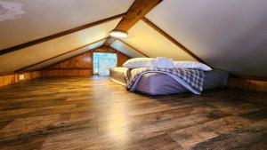 a bedroom with a bed in a attic at Lee's Grand Lake Resort Cabin 4 in Grove +10 photos