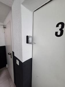 a hallway with a door with the number three on it at M-NOUr in Solingen