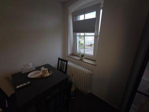 a table with a plate on it and a window at M-NOUr in Solingen