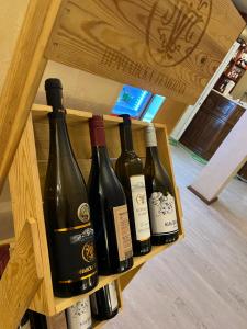 four bottles of wine sitting on a shelf at Семеен Хотел ,,Царева Ливада'' in Tsareva Livada