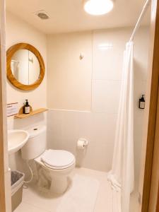a bathroom with a toilet and a sink and a mirror at ETHNIC Thematic Hotel in Cartagena de Indias