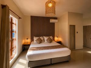 a bedroom with a large bed and a window at ETHNIC Thematic Hotel in Cartagena de Indias