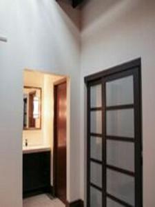 パデューカにあるThe 1857のドア付きの部屋、洗面台付きのバスルームが備わる客室です。