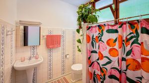 a bathroom with a shower curtain and a sink at Casa Smile in Teresópolis