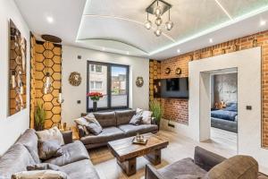 a living room with couches and a brick wall at Ambiente Apartment in Olfen