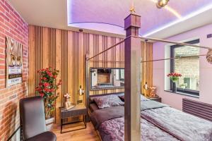 a bedroom with a bed and a brick wall at Ambiente Apartment in Olfen