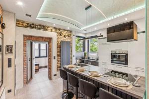 a kitchen with a large island with chairs and a table at Ambiente Apartment in Olfen