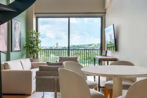 a living room with a couch and a table and chairs at Stylish Duplex Loft - Panoramic Rooftop Pool in Cartagena de Indias