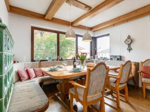 a dining room with a wooden table and chairs at Familien Lodge Fleckalm in Kirchberg in Tirol