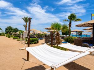 a hammock on the beach at the resort at Sea Star Beau Rivage Hotel in Hurghada
