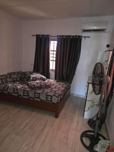 a bedroom with a bed and a window at J&J Guest Apartment in Eggan