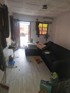 a living room with a black couch and a window at J&J Guest Apartment in Eggan