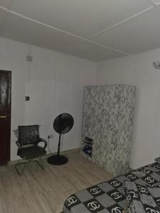 a bedroom with a bed and a chair in it at J&J Guest Apartment in Eggan