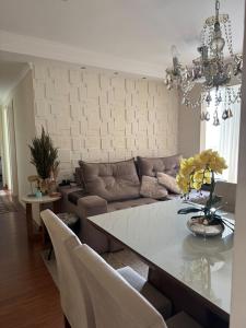 a living room with a couch and a table at Apartamento Serra Espírito Santo in Serra