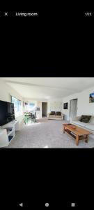 a living room with a couch and a table at Mount Handy Dandy in Mount Maunganui
