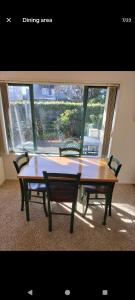 a table and chairs in a room with a window at Mount Handy Dandy in Mount Maunganui