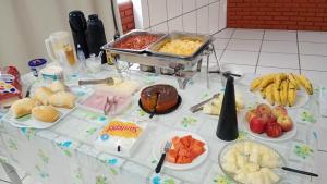 a table with a buffet of food on it at Hotel Santa Thereza in Bofete