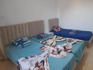 two beds sitting next to each other in a room at Taguermess Tag 6 in Midoun