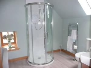 a bathroom with a shower with a glass dome at Clochridgestone Cottage in Aberargie