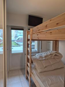 a bunk bed in a room with a flat screen tv at Appartement Esmeralda in Knokke-Heist