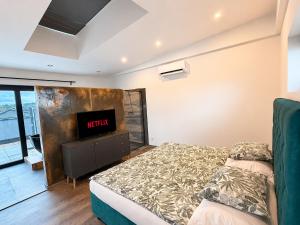a bedroom with a bed and a flat screen tv at Apartmán Natalka7 in Bartovice