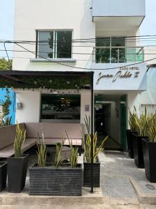 a restaurant with plants in front of a building at Hotel Juan Pablo 2 in Ríohacha